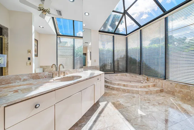 a bathroom with a double vanity sink mirror and toilet