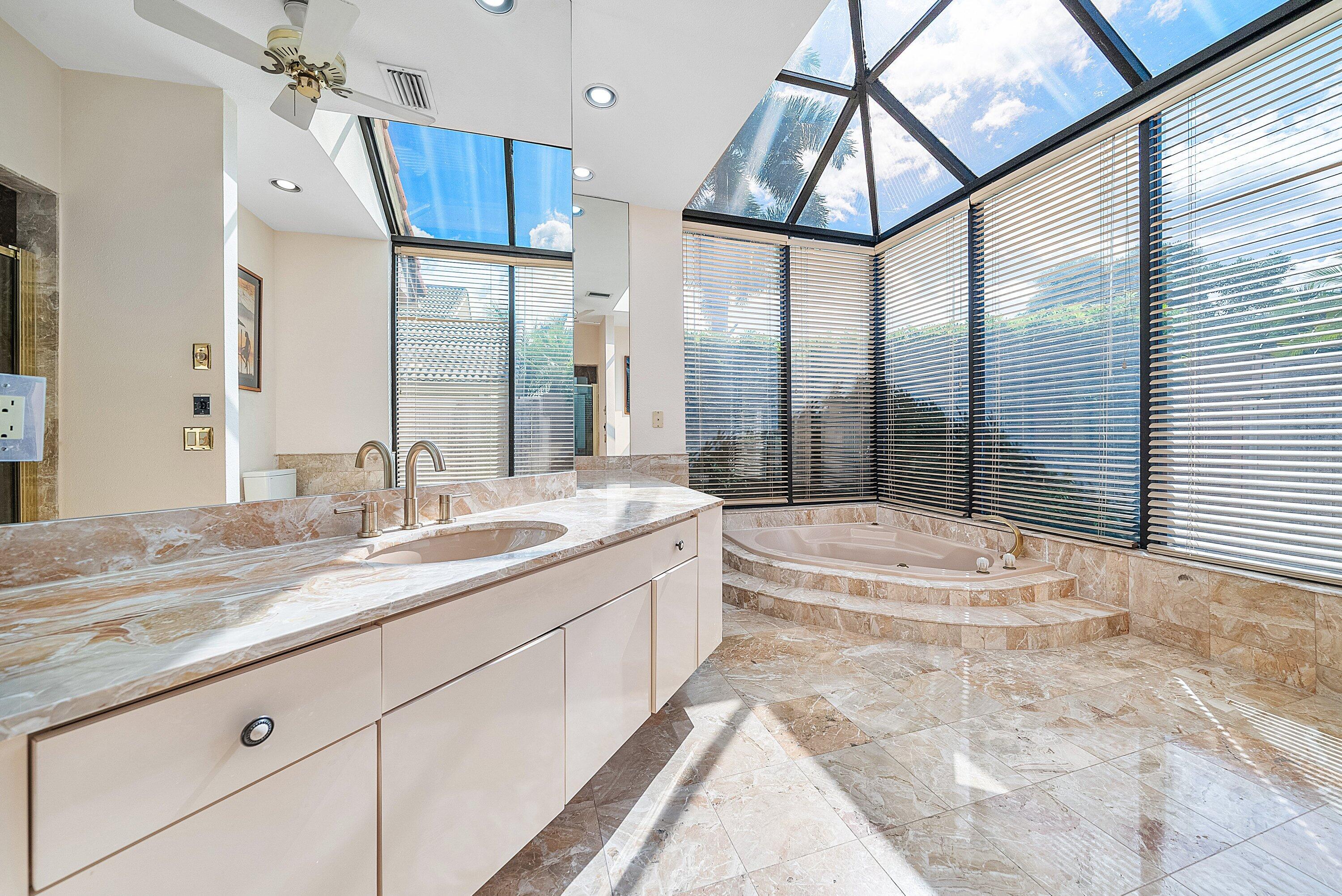 4952 Bocaire Boulevard Boca Raton, FL 33487 - Photo 21 of 61 a bathroom with a granite countertop sink mirror and shower