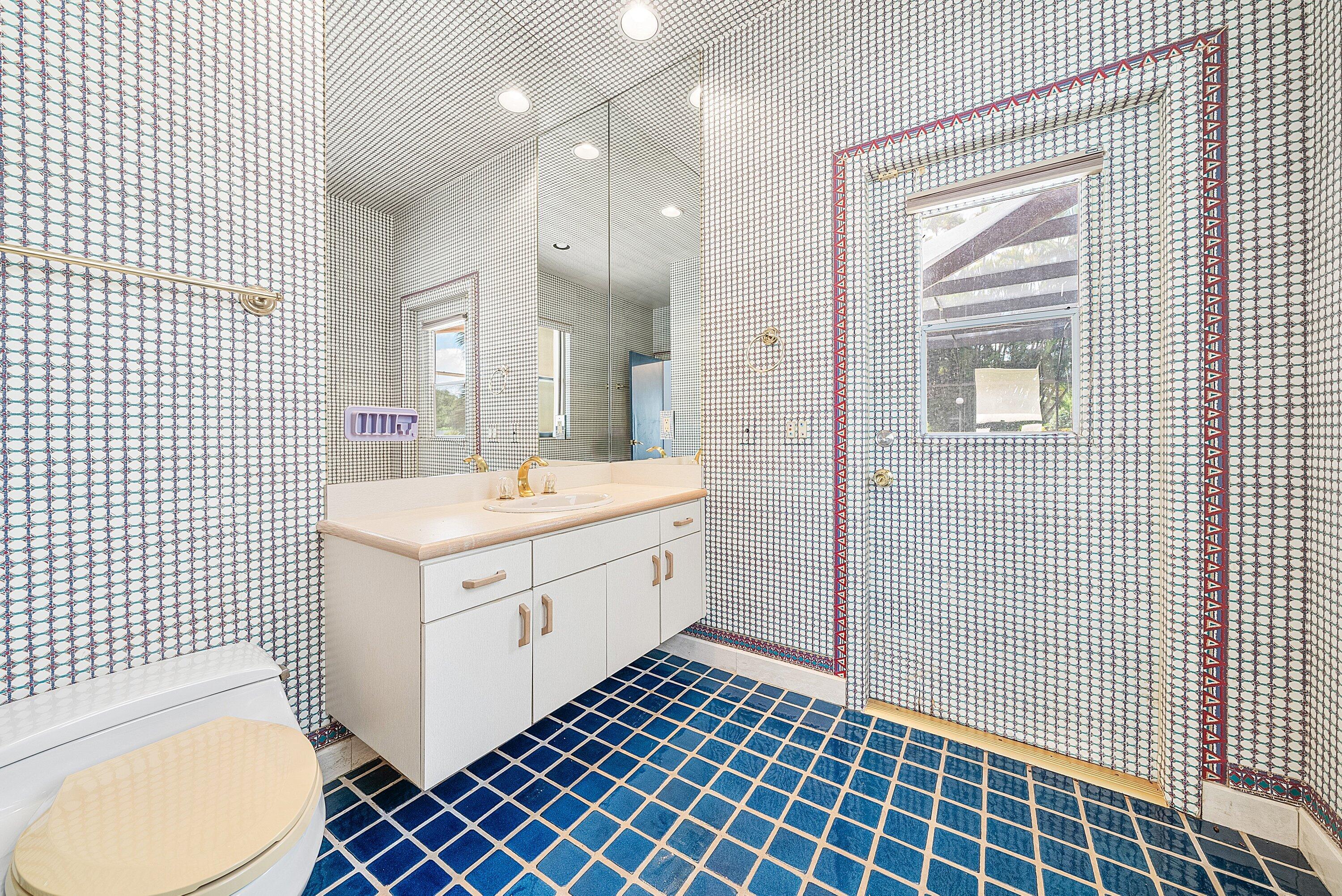 4952 Bocaire Boulevard Boca Raton, FL 33487 - Photo 28 of 61 a bathroom with a double vanity sink mirror and toilet