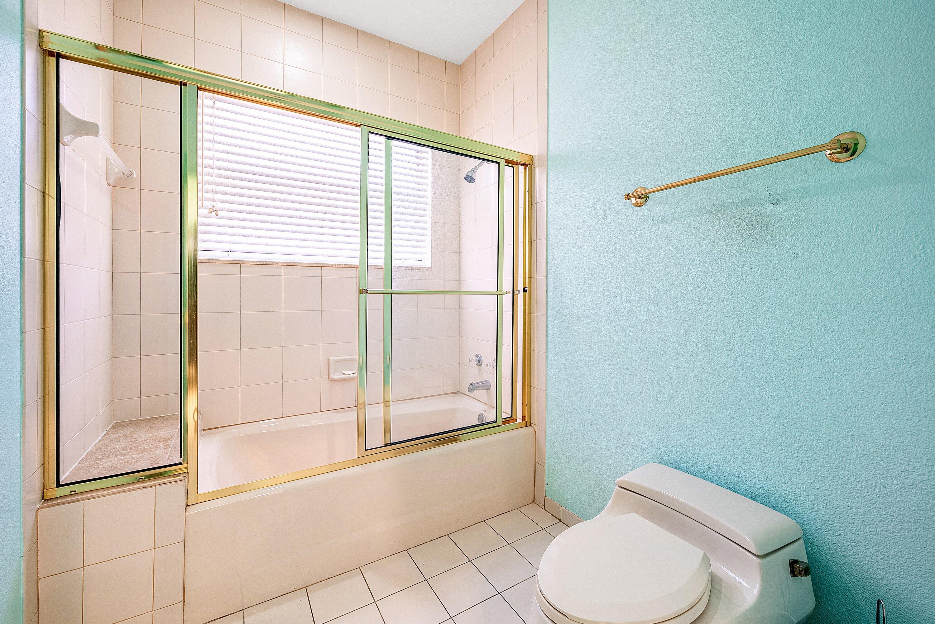 4952 Bocaire Boulevard Boca Raton, FL 33487 - Photo 30 of 61 a bathroom with a toilet a sink and a window