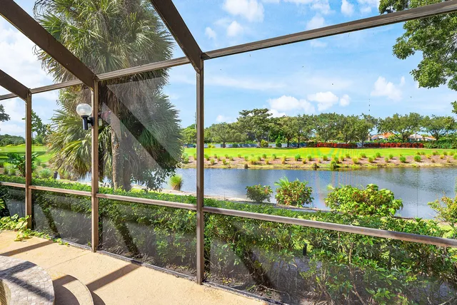 a living room with furniture a flat screen tv and kitchen view