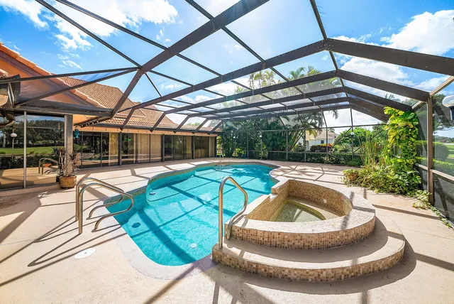 a dining room with stainless steel appliances kitchen island a table chairs in it and wooden floors