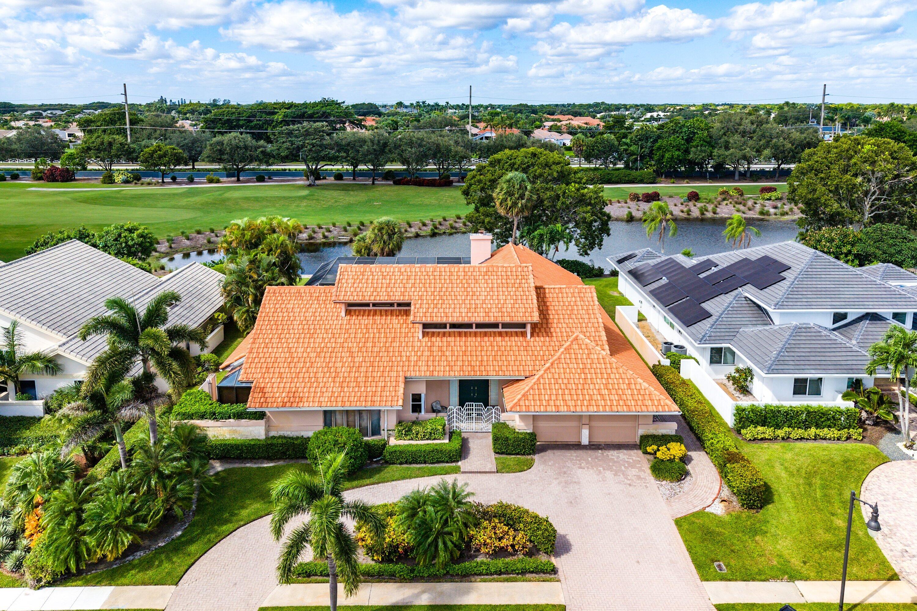 4952 Bocaire Boulevard Boca Raton, FL 33487 - Photo 42 of 61 an aerial view of a house with swimming pool and garden