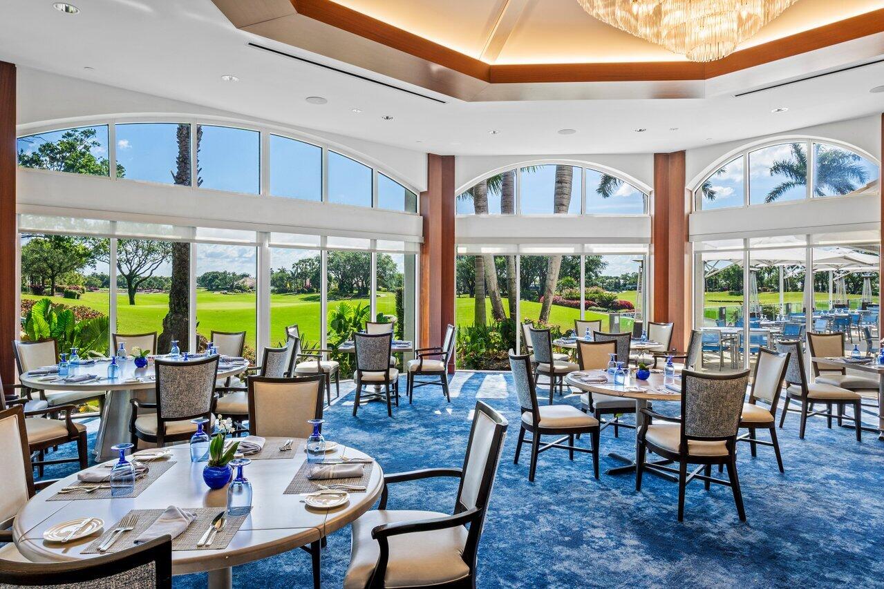 4952 Bocaire Boulevard Boca Raton, FL 33487 - Photo 48 of 61 a view of a dining room with furniture large windows and wooden floor