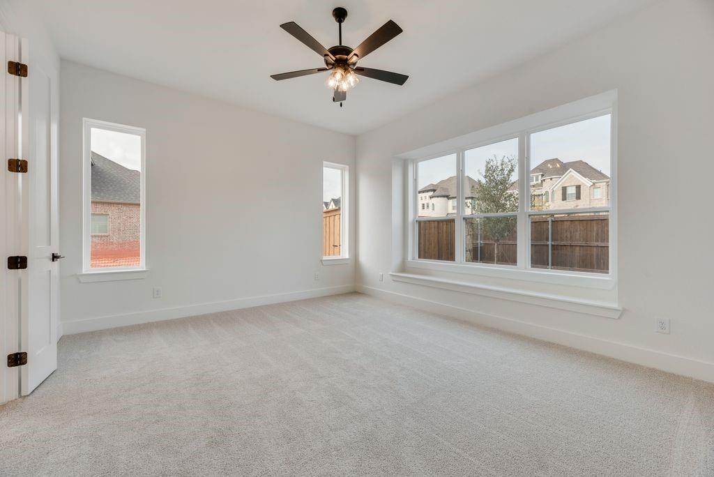 3517 Laurel Court Corinth, TX 76208 - Photo 16 of 30 an empty room with windows and ceiling fan