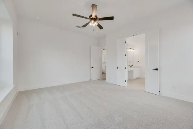 an empty room with closet and windows