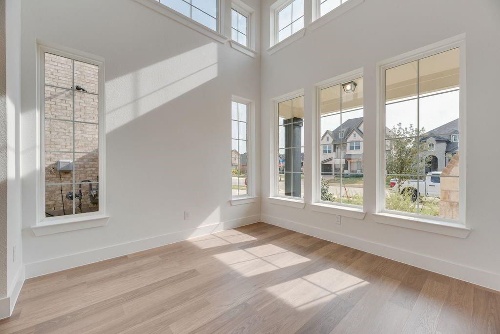 3517 Laurel Court Corinth, TX 76208 - Photo 7 of 30 a view of an empty room with a window and wooden floor