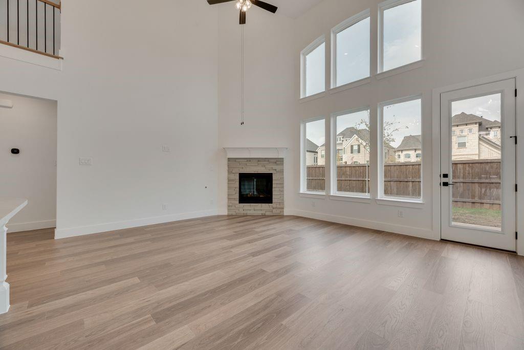 3517 Laurel Court Corinth, TX 76208 - Photo 9 of 30 a view of an empty room with wooden floor and a window
