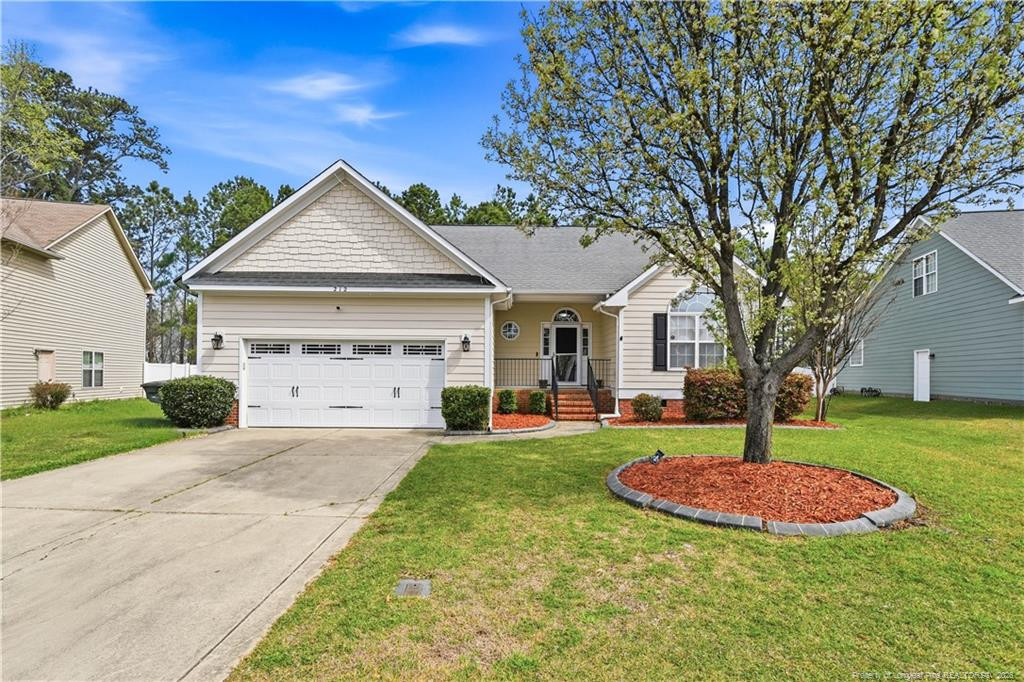 212 Lennox Loop Raeford, NC 28376 - Photo 39 of 47 a front view of a house with a yard and trees