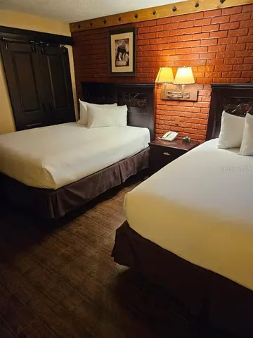 a bedroom with two beds and a closet