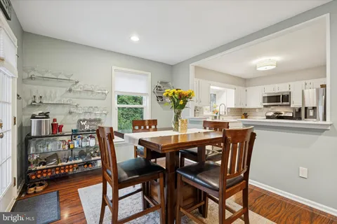 a dining room with furniture and wooden floor