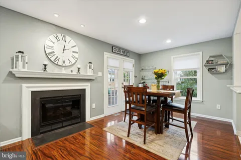 a view of a a dining room with furniture window and wooden floor