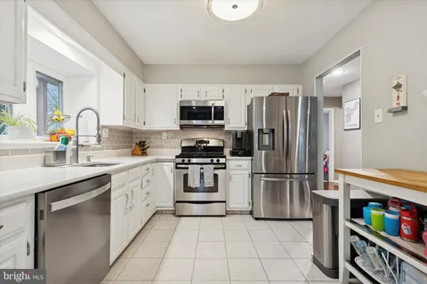 a kitchen with a refrigerator and a sink