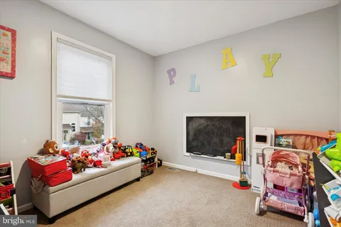 a room with toys and a flat screen tv