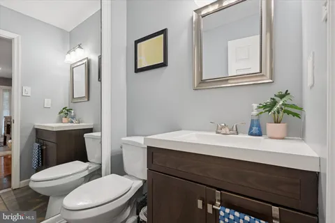 a bathroom with a sink a toilet and mirror