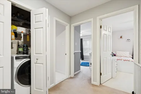 a view of a hallway with washer and dryer