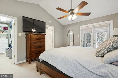 a bedroom with a bed and a ceiling fan