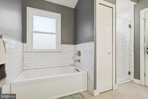 a white bath tub sitting next to a white sink