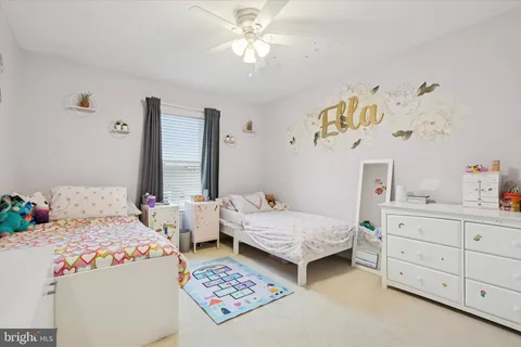 a bedroom with two beds and a window