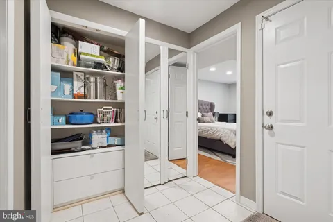a kitchen with a refrigerator and white cabinets