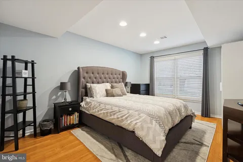 a bedroom with a bed and large window