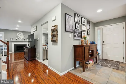 a view of a hallway with wooden floor and furniture