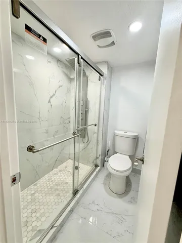 a bedroom with a bed and a night stand