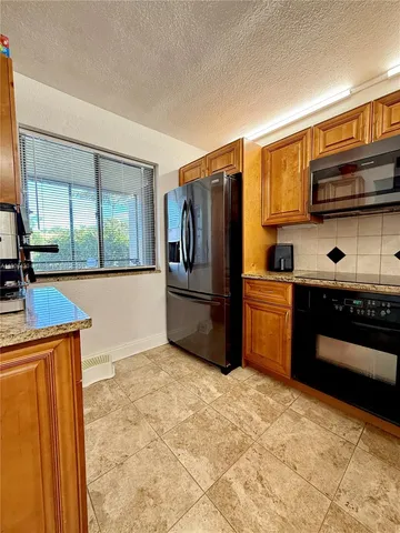 a living room with furniture a air conditioner and a table