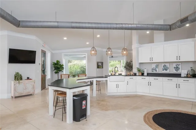 a large white kitchen with cabinets