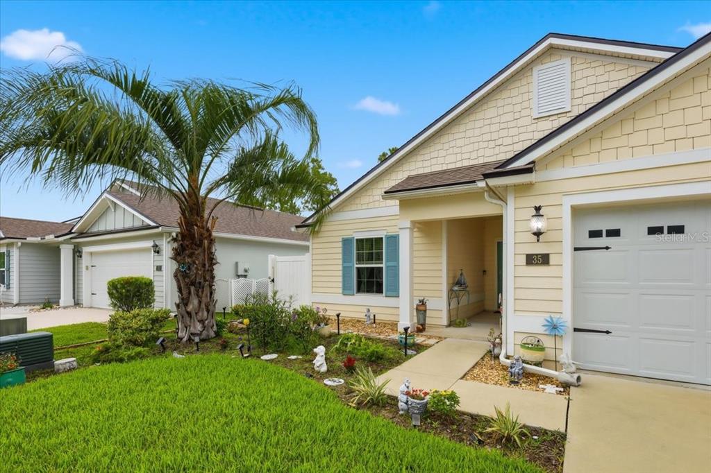 35 Birdie Way Bunnell, FL 32110 - Photo 47 of 57 a view of a house with a small yard and potted plants