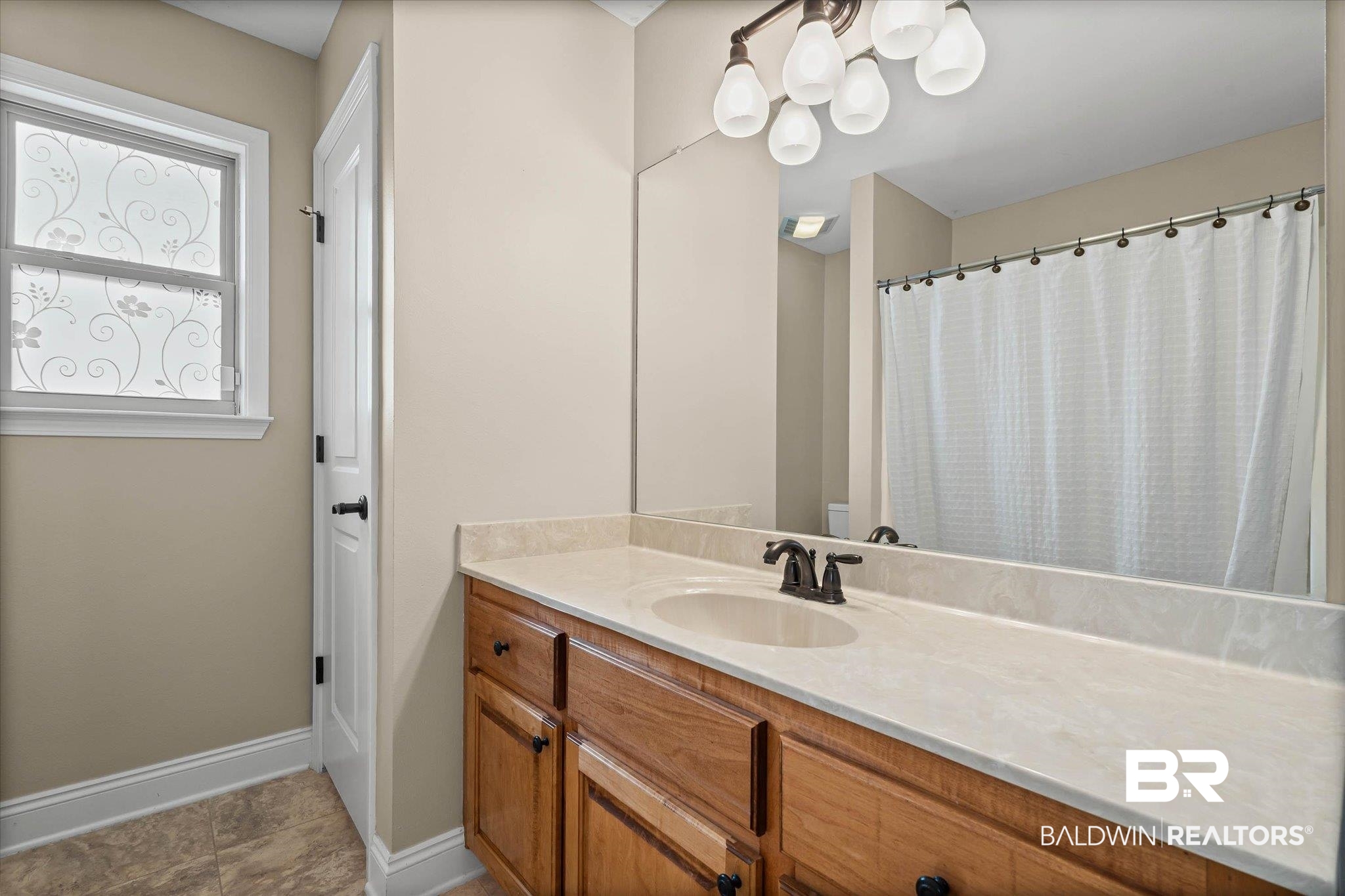 704 Edinburgh Avenue Foley, AL 36535 - Photo 26 of 32 Full bathroom featuring vanity and a shower with curtain
