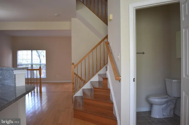 a view of entryway and hall with wooden floor