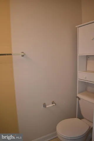 a white toilet sitting next to a shower