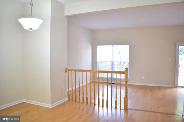 a view of hallway with wooden floor