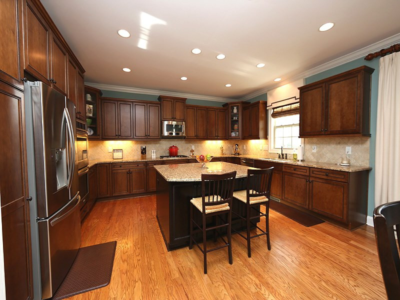 12913 Baybriar Drive Raleigh, NC 27613 - Photo 9 of 25 WOW! A chef's delight with an abundance of upgraded cabinets, including extra storage under the large island. The appliances include double ovens, microwave, dishwasher and 5 burner range. You will find under cabinet lighting to accent the tile & granite. Gourmet Kitchen
