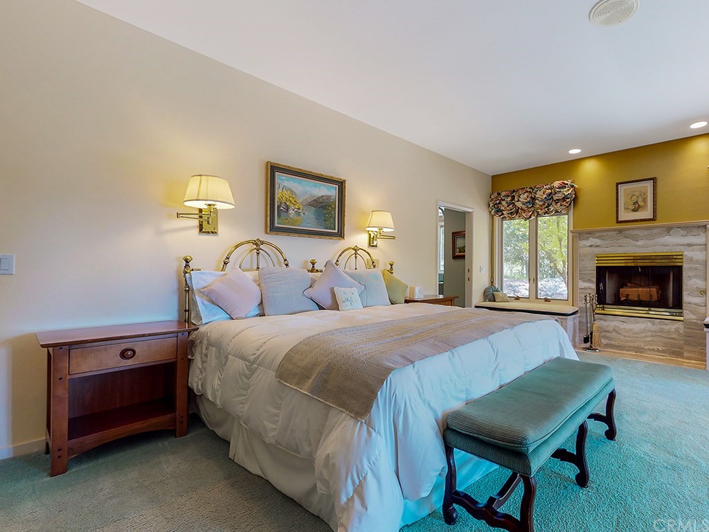 8800 Vineyard Drive Paso Robles, CA 93446 - Photo 24 of 74 a spacious bedroom with a bed and a fireplace