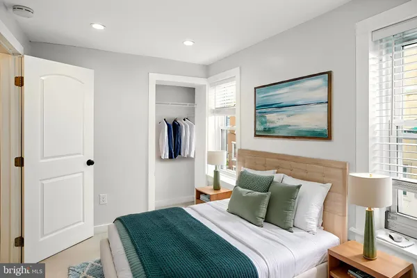 a bedroom with a bed and a painting on the wall