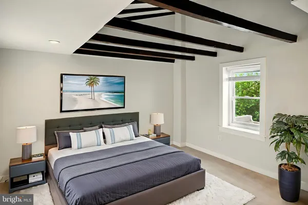 a bedroom with bed and wooden floor