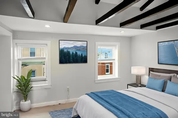 a bedroom with a bed and a potted plant