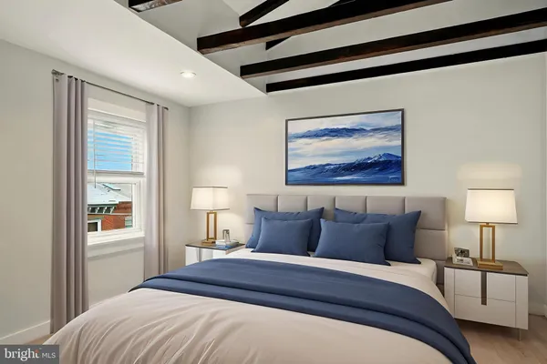 a bedroom with a bed and a painting on the wall