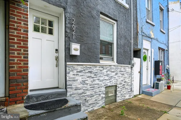 a view of front door of house with stairs