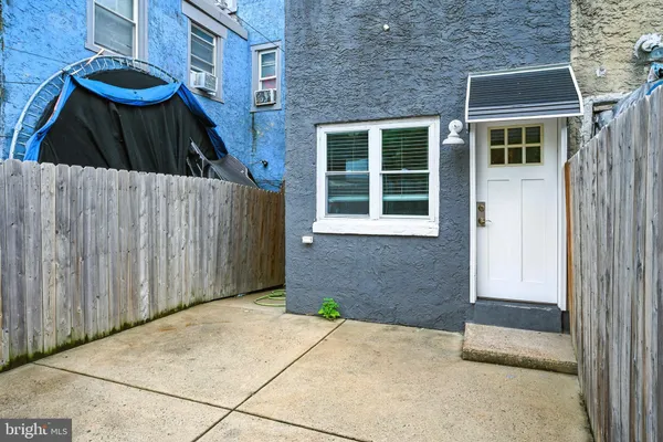 a view of a house with backyard and wooden door