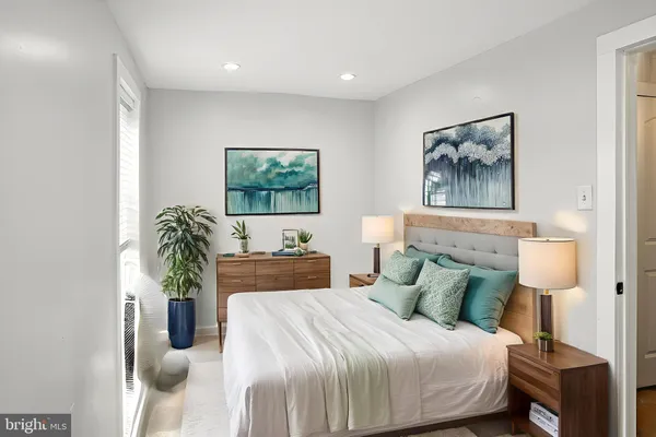 a bedroom with a bed and a potted plant