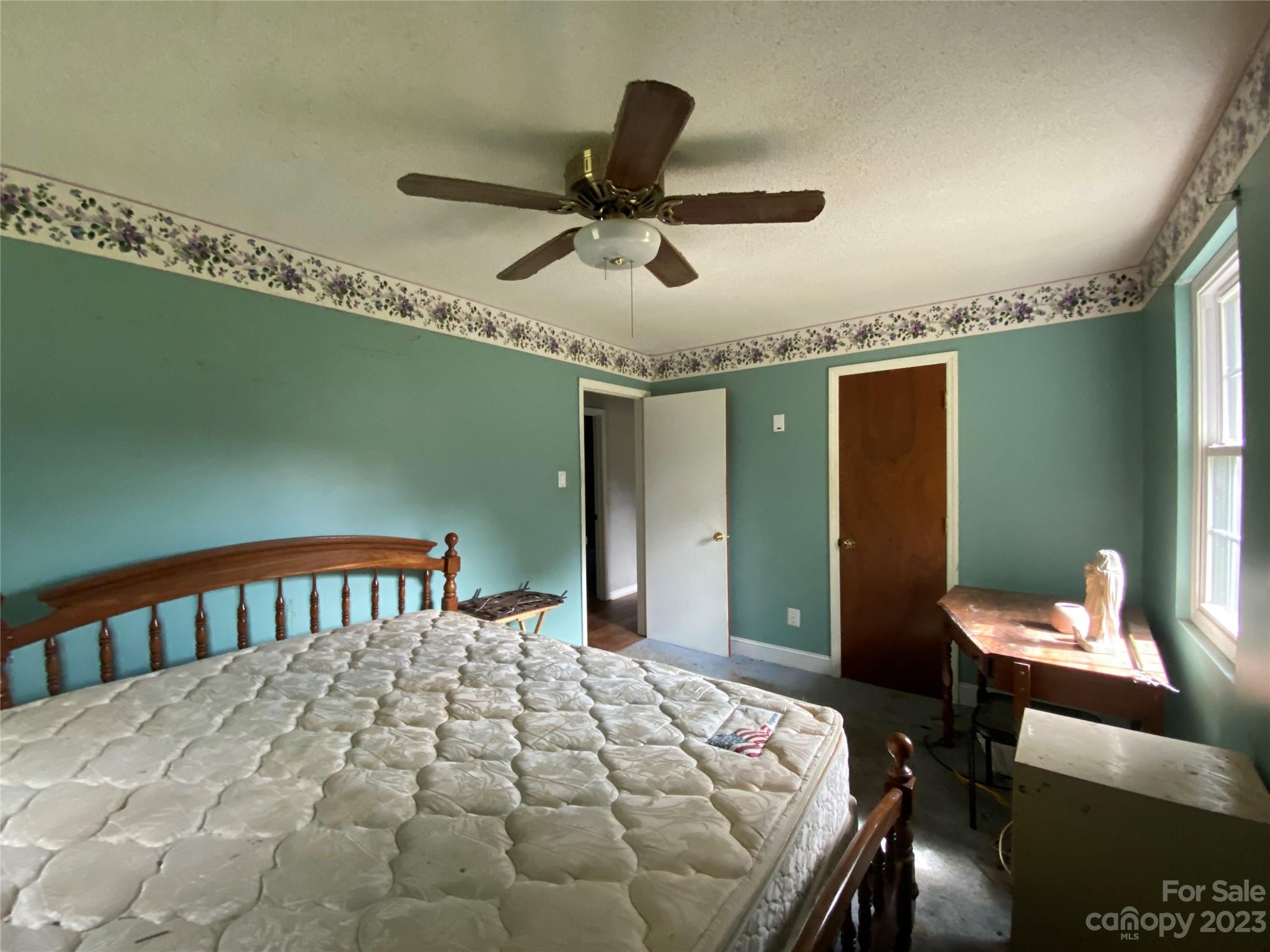 2320 Crescent Road Salisbury, NC 28146 - Photo 36 of 48 a bedroom with a bed and a chandelier