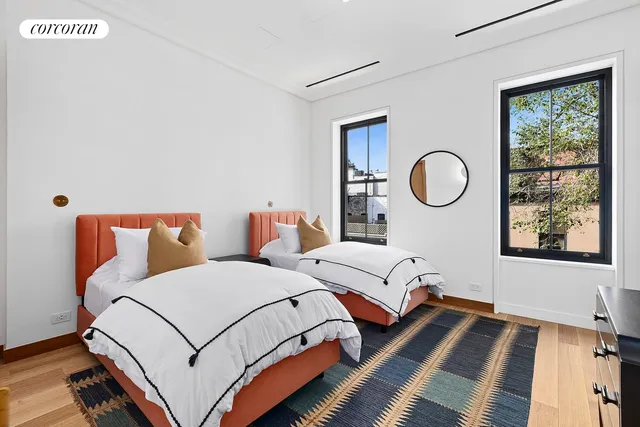 a spacious bedroom with a bed and window