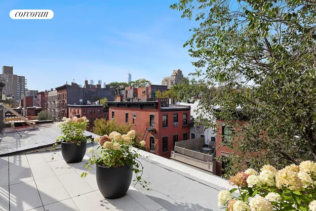 a balcony view with a fireplace and potted plants