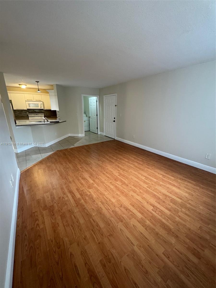 4025 West McNab Road, Unit E109 Pompano Beach, FL 33069 - Photo 5 of 13 a view of a room with wooden floor and a sink