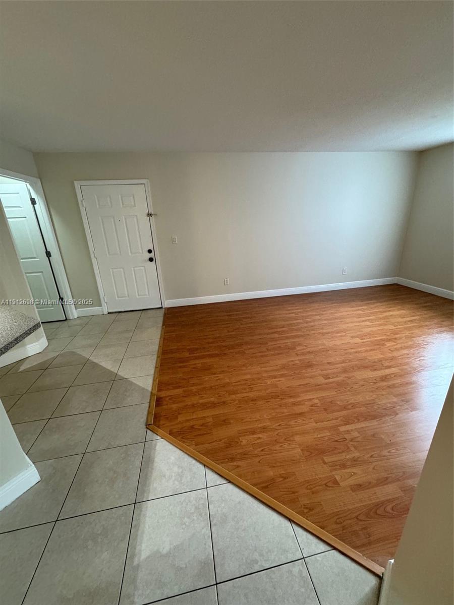 4025 West McNab Road, Unit E109 Pompano Beach, FL 33069 - Photo 7 of 13 a view of an empty room and window