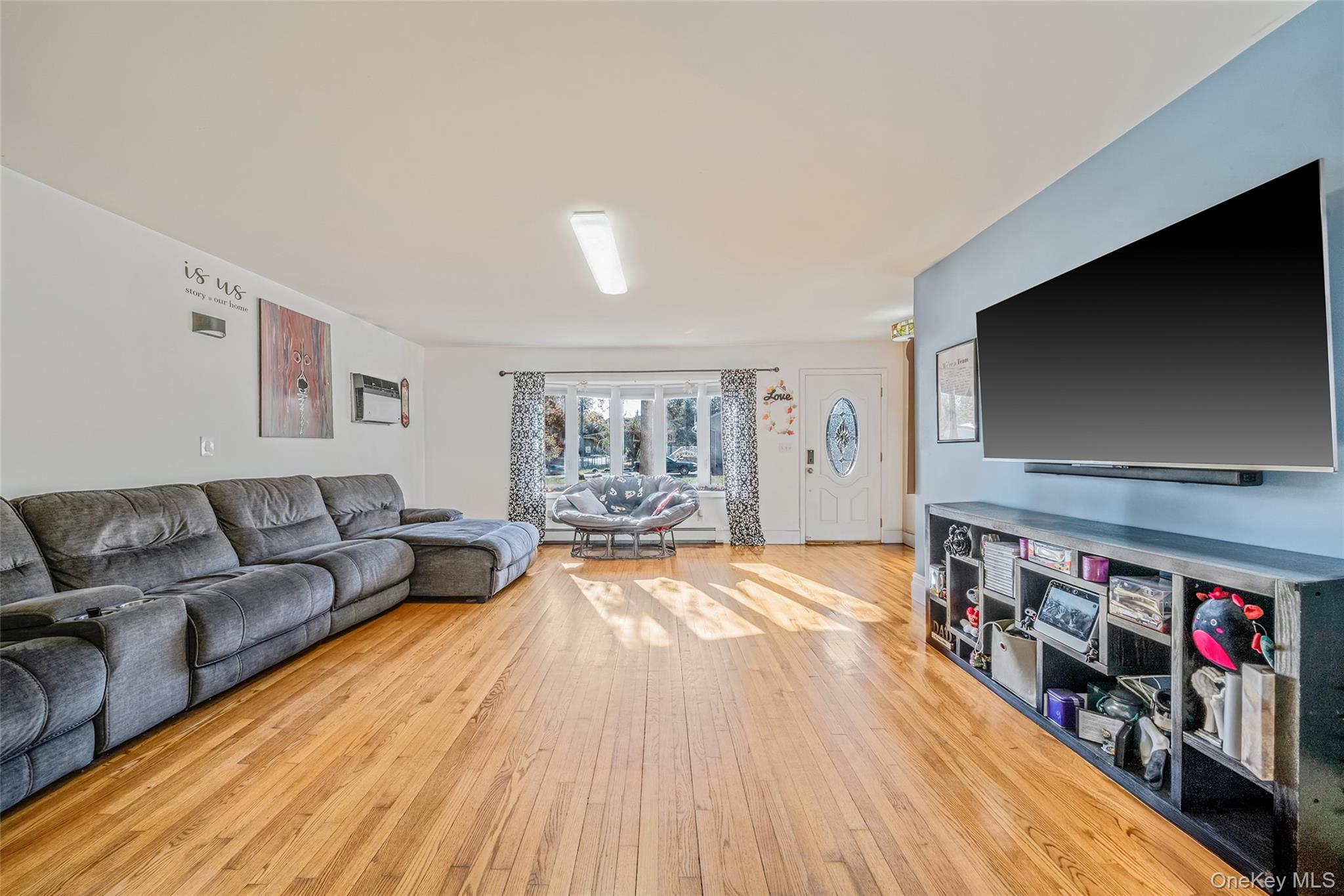 267 Dogwood Road West Mastic Beach, NY 11951 - Photo 17 of 30 a living room with furniture and a flat screen tv