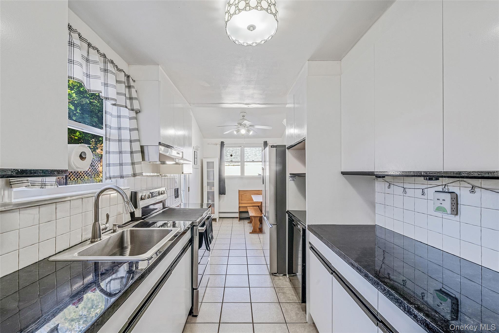 267 Dogwood Road West Mastic Beach, NY 11951 - Photo 20 of 30 a kitchen with stainless steel appliances granite countertop a sink stove and cabinets